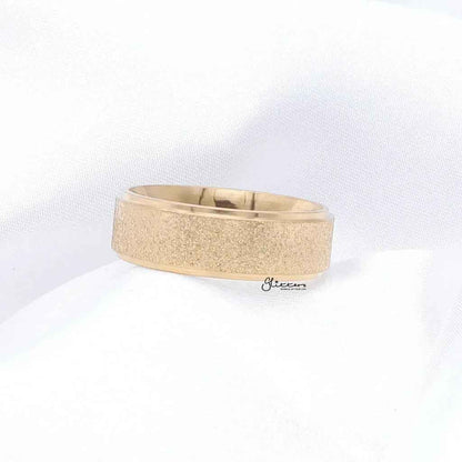 Gold stainless steel band ring with sandblasted finish, 8mm width, by Glitters, shown in close-up on a white background.