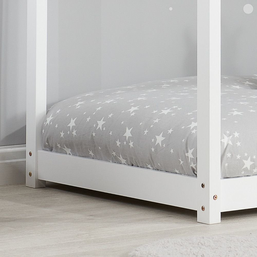 White single kid bed frame from Sue-e Furniture, featuring a sturdy design with a clean, modern look in a cozy bedroom setting.