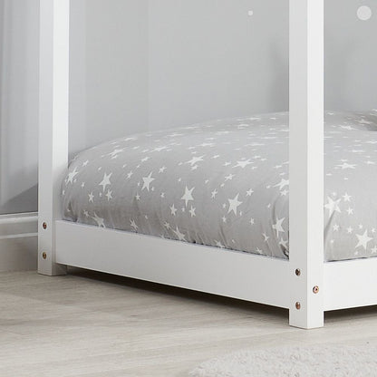 White single kid bed frame from Sue-e Furniture, featuring a sturdy design with a clean, modern look in a cozy bedroom setting.