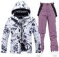 Pink men's and women's waterproof ski suit by Mead's Supply & Equipment, featuring a jacket and pants for winter snow sports.