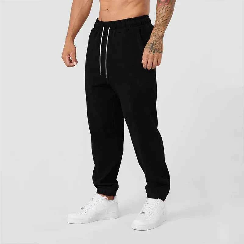 Men's black athletic joggers from Mead's Supply & Equipment Outfitters with side stripe, designed for comfort and active wear.