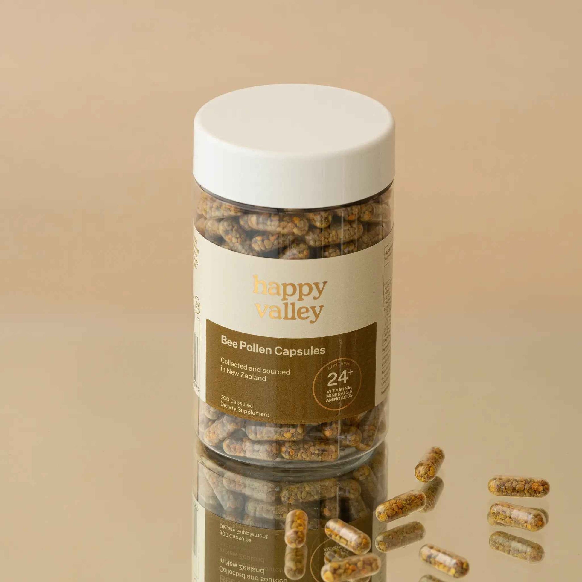 Close-up of Happy Valley Honey Bee Pollen Capsules 300, showing the smooth, yellow capsules in a clear container.