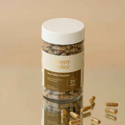 Close-up of Happy Valley Honey Bee Pollen Capsules 300, showing the smooth, yellow capsules in a clear container.